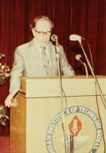 A speaker addresses an audience during an event