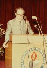 A speaker addresses an audience during an event