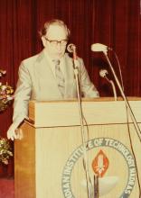 A speaker addresses an audience at IIT Madras