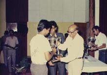 A trophy being presented to a person during the 29th Institute Day, 1988