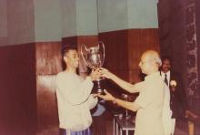 An elated student receives a trophy, 1994