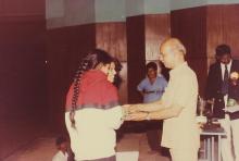 Two girls receive a prize from Prof. Y. Narayana Rao, 1994