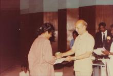 A girl receives a prize from Prof. Y. Narayana Rao, 1994