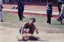 A student lands in the landing pit during a jump event, 1999