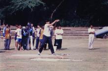 A student takes part in a discuss throw event, 1999