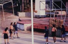 A student takes a free throw attempt during a basketball match, 1999