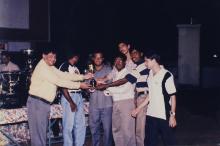 Prof. R. Natarajan presents a trophy to a group of students, 1999