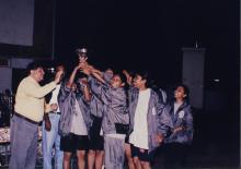 A group of girls lift a trophy, 1999