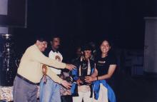 A couple of girls receive a trophy from Prof. R. Natarajan, 1999