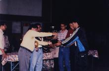 Prof. R. Natarajan presents a trophy to a group of students, 1999
