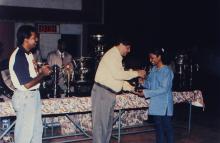 Prof. R. Natarajan presents a trophy to a young woman, 1999