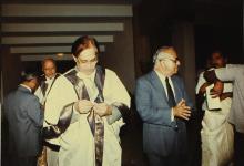 The chief guest Mr. K. L. Chugh buttons up his convocation robe as Dr. M. S. Swaminathan and Prof. N. V. C. Swamy converse with people at the back during the 30th Convocation, 1993