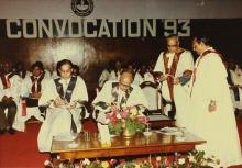 Dr. M. S. Swaminathan, Chairman, Board of Governors, signs the register of degrees during the 30th Convocation in 1993.   Also seen in the image are Mr. K. L. Chugh, Chairman of ITC Limited, Calcutta and Prof. N. V. C. Swamy, Director.