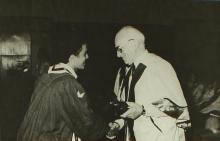 A graduating student receives his prize from the chief guest at a convocation ceremony 