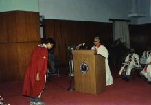 Student bowing down before receiving degree at the 26th Convocation, 1989