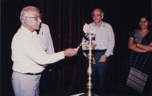 A member of the faculty lights the kuthuvizhaku