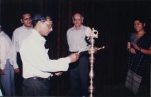 A member of the faculty lights the kuthuvizhaku