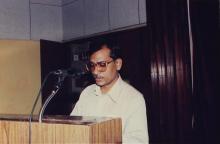 A administrator or member of the faculty addresses the audience