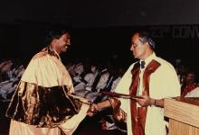 The Director distributes degree certificates to students