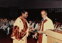 The Director distributes degree certificates to students