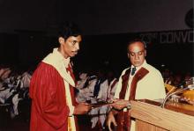 The Director distributes degree certificates to students