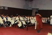 A student bows to the distinguished guests before receiving his degree