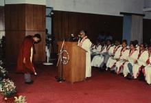 A student bows to the distinguished guests before receiving his degree
