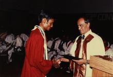 The Director distributes degree certificates to students