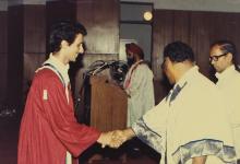 An award winner is greeted by the chief guest