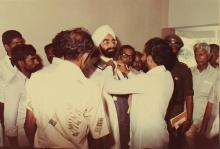 Mr. Giani Zail Singh being helped with convocation robes, 1983