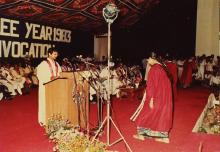 A graduand walks up to the podium to receive her degree, 1983