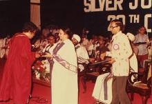 A graduand receives his degree, 1983