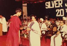 A graduand receives his degree, 1983