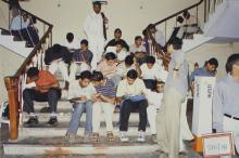 Participants poring over sheets of paper, 2003