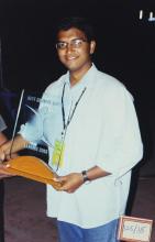 A person poses with a trophy at Saarang 2003