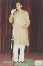 A participant sings during an event, 2003
