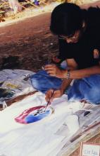 A girl paints a T-shirt at Saarang, 2003