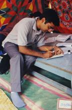 A participant photographed while participating in what appears to be a calligraphy workshop, Saarang 2003