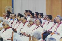 A photograph of the faculty members seated on the stage at the 41st convocation, 2004