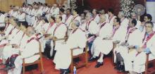 A photograph of the faculty members seated on the stage at the 41st convocation, 2004