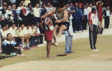 Audience members watch a high jump competition at the 12th Inter-IIT Staff Sports Meet, 2004