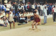 A participant lands after a high jump at the 12th Inter-IIT Staff Sports Meet, 2004