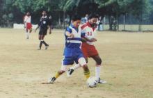 Two people compete for the ball during a football match at the 12th Inter-IIT Staff Sports Meet, 2004
