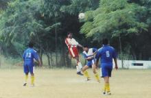 Players captured in motion during a football match at the 12th Inter-IIT Staff Sports Meet, 2004