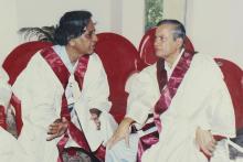 Two faculty members speaking to each other at the 42nd Convocation, 2005