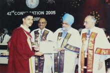 A student poses for a photograph after receiving a degree at the 42nd Convocation, 2005