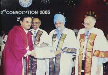 A student poses for a photograph after receiving a degree at the 42nd Convocation, 2005