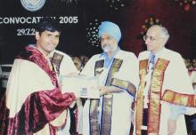 A student receives a degree certificate at the 42nd Convocation, 2005