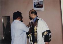 Mr. U. R. Rao is assisted with his convocation robes, 1998
