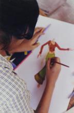 A student participating in the art competition, is seen working on an art piece